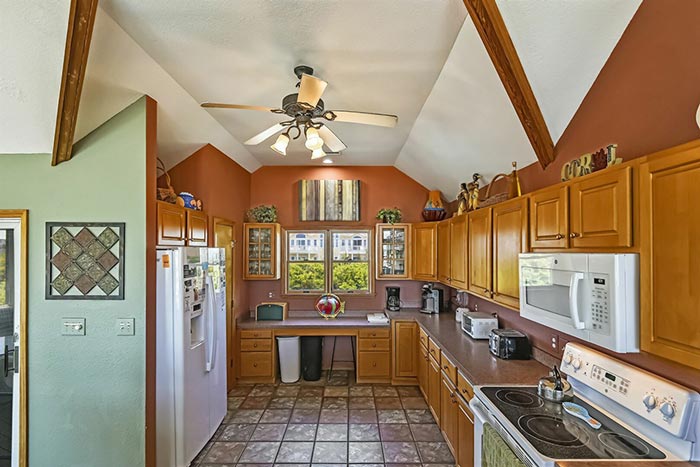 Open concept kitchen in a semi-oceanfront Outer Banks Beach Rental Home in Corolla, North Carolina.